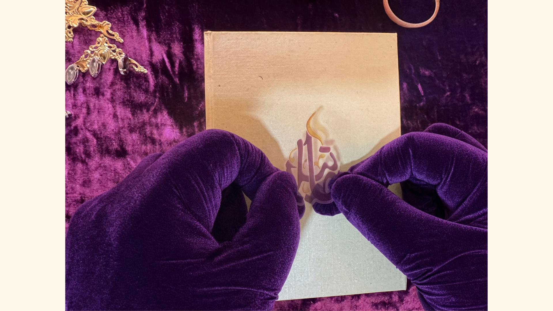 Purple-gloved hands positioning the House sigil on a gold presentation box.